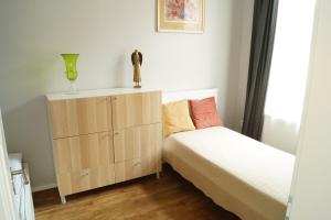 a bedroom with two beds and a dresser in it at Apartmány Mary in Litoměřice