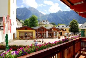 a view of a town with flowers and mountains at Gasthof Weißes Rössl in Abtenau