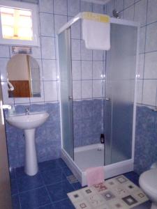 a bathroom with a shower and a sink and a toilet at Casa VIO in Sighişoara