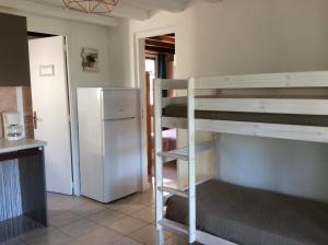 a room with two bunk beds and a refrigerator at Résidence île de beauté in Propriano