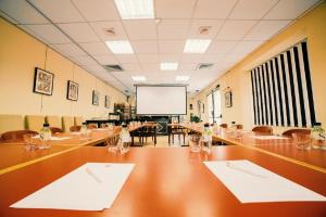 a large conference room with a long table and a screen at Napoleon in Ajaccio