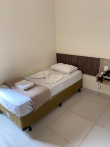 a small bed in a room with at Astro Palace Hotel in Uberlândia