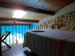 a bedroom with a bed and a large window at Affittacamere Accà Lascio in Calascio