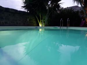 a swimming pool at night with blue water at Bouganville- Le casette di Marilena b&b in Pantelleria