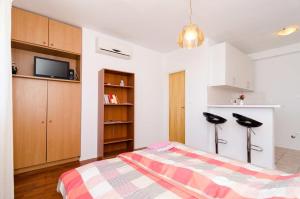 a bedroom with a bed and a flat screen tv at Villa Arka in Cavtat