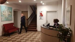 a man walking through a lobby with a woman in a office at Hotel Pension Blüchersruh in Bad Berneck im Fichtelgebirge