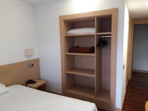 ein Zimmer mit einem Bett und einem Bücherregal in der Unterkunft Hotel Puigcerdà in Puigcerdà + 42 Fotos