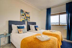 1 Schlafzimmer mit 2 Betten und einem Fenster in der Unterkunft Ocean Blue Apartment & Studio in Monte Estoril