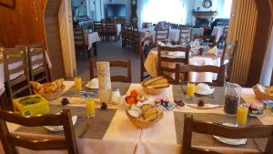 a dining room with a table with food on it at Le Guilazur in Château-Ville-Vieille