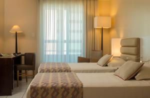 Postel nebo postele na pokoji v ubytování Hotel Luzeiros Fortaleza