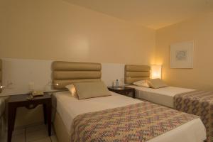 Postel nebo postele na pokoji v ubytování Hotel Luzeiros Fortaleza