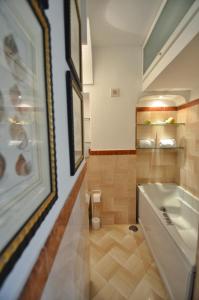 a bathroom with a tub and a sink at CASA GADEAMUS via le botteghe 12 in Capri