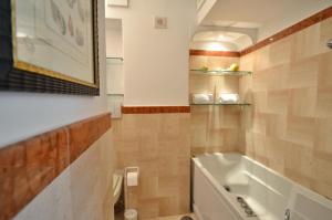 a bathroom with a tub and a sink at CASA GADEAMUS via le botteghe 12 in Capri