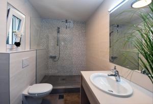 a bathroom with a sink and a toilet and a shower at Modern & Comfy Sea View House NG in Portorož +10 photos