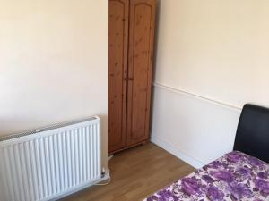 a corner of a room with a radiator and a chair at Seaside resort in Felixstowe