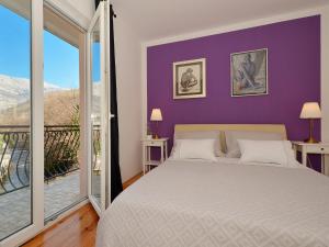 a bedroom with a bed and a large window at Holiday Home Žrnovnica in Žrnovnica +31 photos