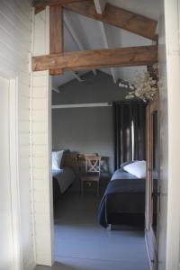 a bedroom with two beds and a table in it at Buitenuit in Boxtel