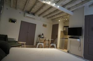 a room with a bed and a kitchen and a living room at Studio typique et cosy climatise. in Arles