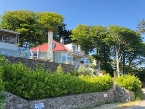 a house with a brick wall and trees at Moult Sylvan in Salcombe