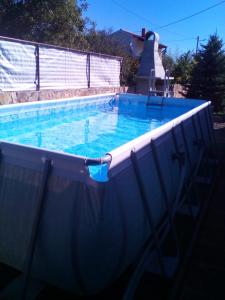 a large swimming pool with blue water in it at Andrija Apartment in Krnica
