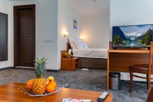 a hotel room with a bed and a bowl of fruit on a table at Panorama Hotel - Free EV Charging Station in Varna City
