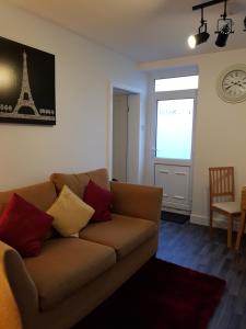 a living room with a couch and a window with the eiffel tower at The Snug at Plover Cottage Lindley in Huddersfield