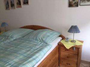 ein Schlafzimmer mit einem Bett und zwei Lampen auf einem Nachttisch in der Unterkunft Theodor Storm Unterkünfte 2 in Husum