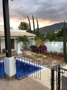 a villa with a swimming pool and a house at Casa Al Pie De La Sierra in Oaxaca City