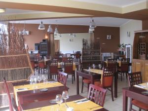 a dining room with tables and chairs in a restaurant at Hotel Restaurant Rive Gauche in Bessines-sur-Gartempe +28 photos