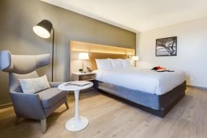 a hotel room with a bed and a chair at Radisson Hotel Salt Lake City Downtown in Salt Lake City +103 photos
