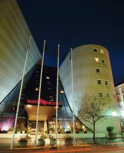 a large building with a hotel on it at night at Mercure Chambéry Centre in Chambéry
