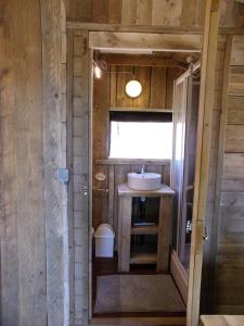 a small bathroom with a sink and a window at Cortijo Dos Santos in Valle de Abdalagís