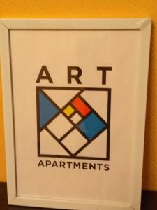 a sign on a wall that says art experiments at Apartment Stepana Bandery Street in Rivne