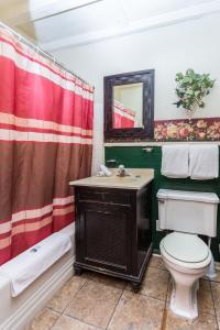a bathroom with a toilet and a sink and a shower at Apple Creek Cottages in Prescott