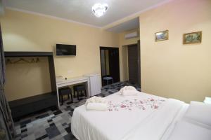 Postel nebo postele na pokoji v ubytování Quest House Lihong