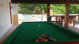 a pool table with balls on top of it at Vale dos Baroes in Paraíba do Sul