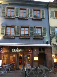 a building with tables and chairs in front of it at Studio Grand Rue in Colmar