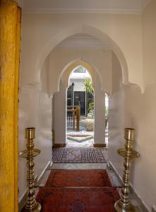 
a stairway leading to a large room with a clock on it at Riad Matins De Marrakech in Marrakesh
