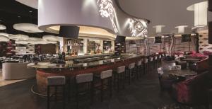 a bar in a restaurant with bar stools at Nobu Las Vegas, A Caesars Destination in Las Vegas