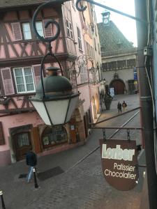 an alley with a street light and a building at Studio Grand Rue in Colmar +1 photo