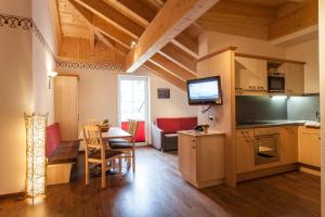 a living room with a kitchen and a dining room at Alpenapart Ladis im Sommer inkl Super Sommer Card in Ladis