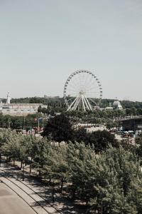 a ferris wheel in a park with trees at Lofts du Vieux-Port by Gray Collection in Montréal