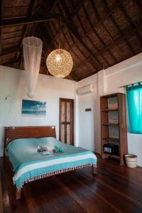 
a bedroom with a bed and a canopy at Surfing Carabao Beach Houses in General Luna

