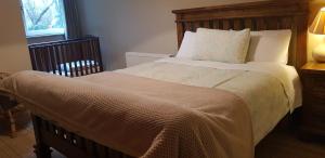 a bedroom with a large bed with a wooden headboard at Ethan House in Killarney