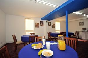 a dining room with a blue table with food on it at Motel Zuma in Williamsburg