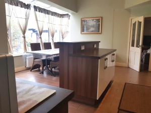 a kitchen with a table and a dining room at Ethan House in Killarney