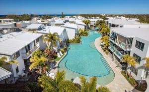 an aerial view of a swimming pool in a resort at Sand Dunes Resort Accommodation in Marcoola