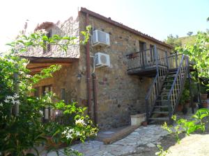 a brick building with a staircase on the side of it at Alla Finestra Sul Parco in Cefalù
