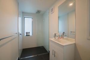 a bathroom with a sink and a mirror at Amazing Sea Views Luxury Guest House in Hobart