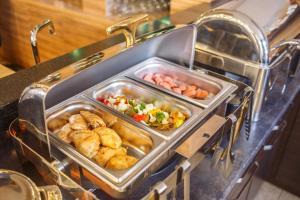 a tray of food in an oven with food in it at Solutel Hotel in Bishkek